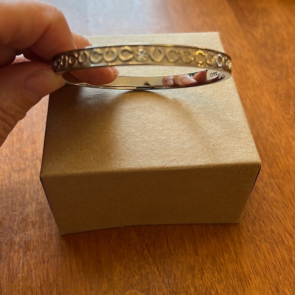 Coach bangle bracelet. Silver with cubic zirconium diamonds (4). Like new.